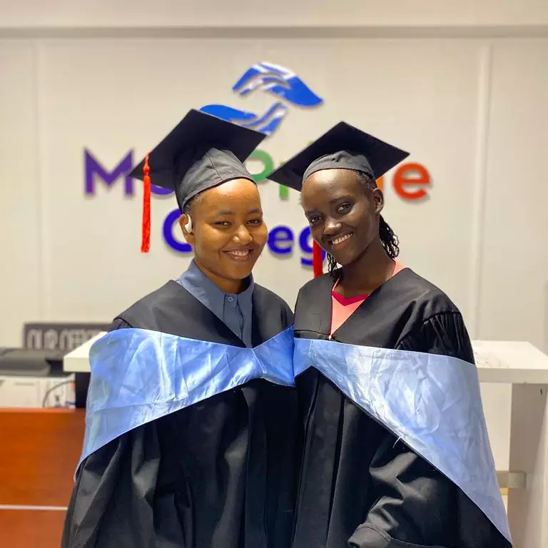 A group of students smiling and socializing on campus.